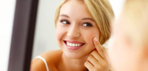 Woman applying skin cream